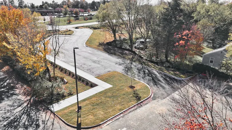 Aerial view of a finished commercial site with curbed parking field