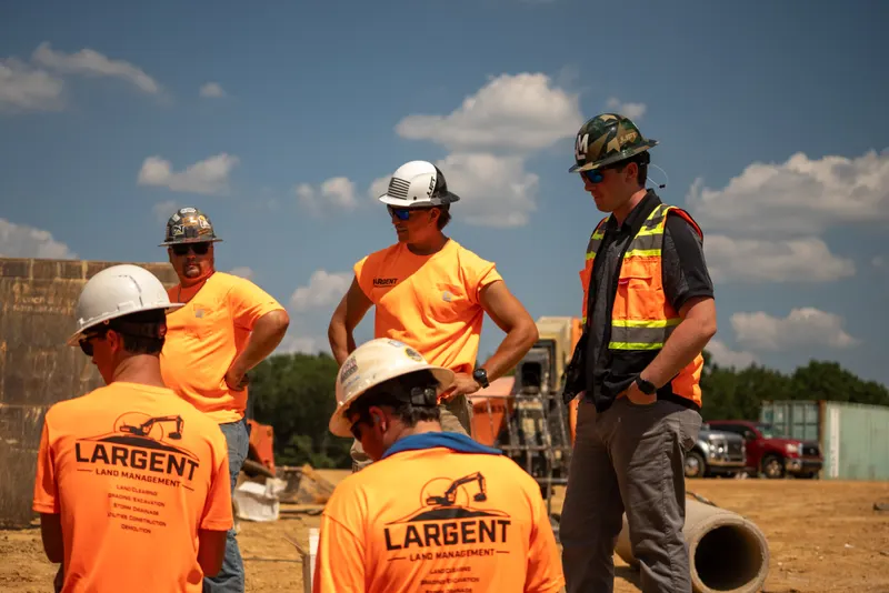 Largent crew in hard hats talking through the next pick